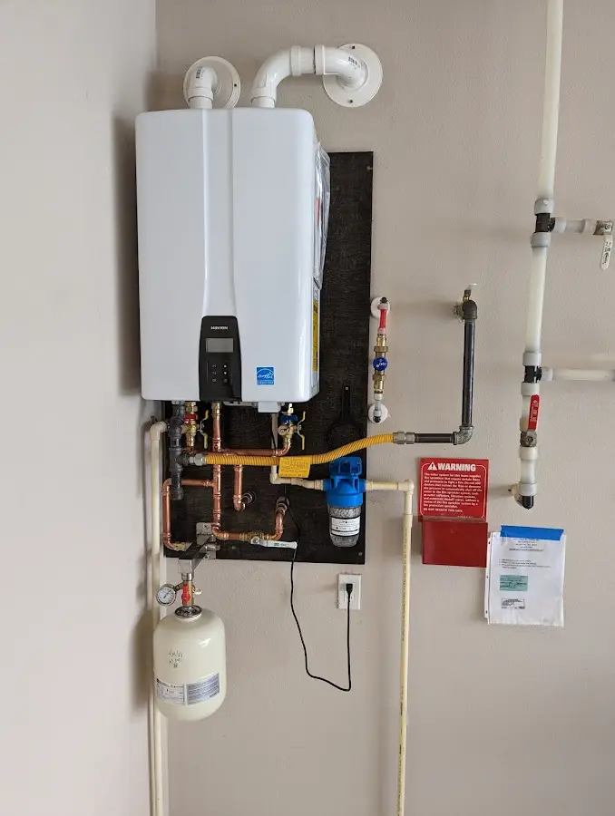 Professional plumber installing copper piping in a Champion Heights home